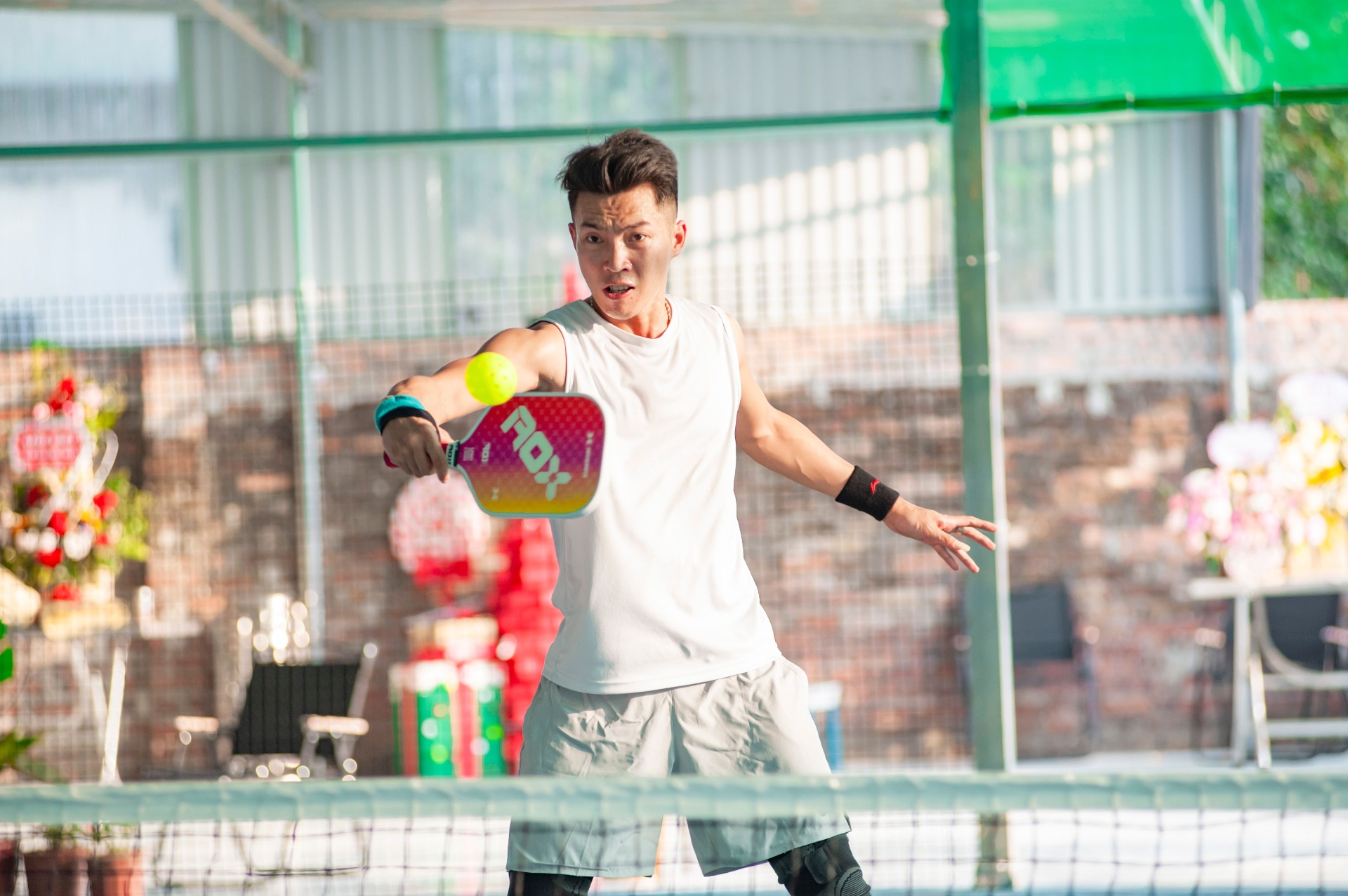 Pickleball player returning a shot at the net